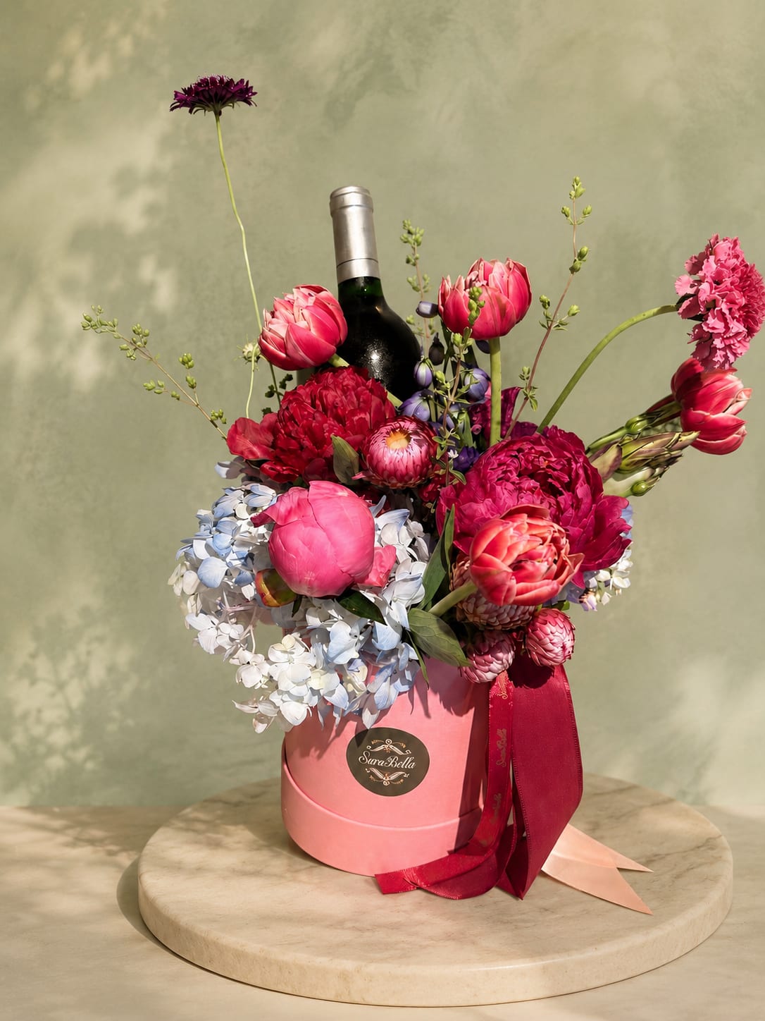 Rosé Celebration Box - “A luxurious floral gift box featuring vibrant peonies, tulips, hydrangeas, and premium seasonal blooms paired with a bottle of your favorite . Rich in color and elegance, this arrangement is perfect for celebrations, anniversaries, and unforgettable moments.”