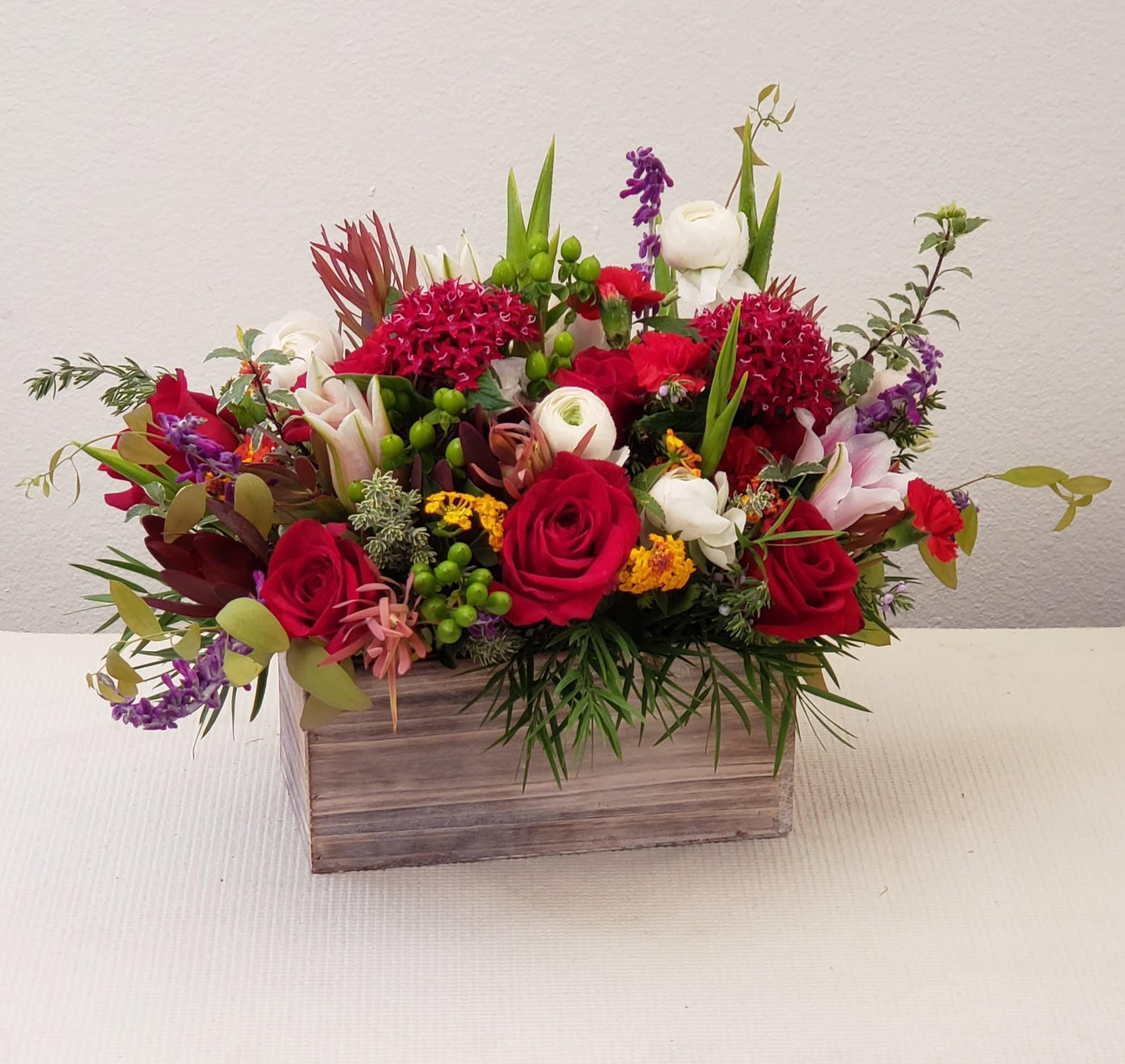 OC Seasonal Garden - This gift is in a seasonal variety of fresh flowers, bright colors, and seasonal accents. Handcrafted into an oasis in a wooden box, ready to enjoy. For long-lasting blooms, add water daily to help flowers last longer. Approximately 15"H x 22" W. 