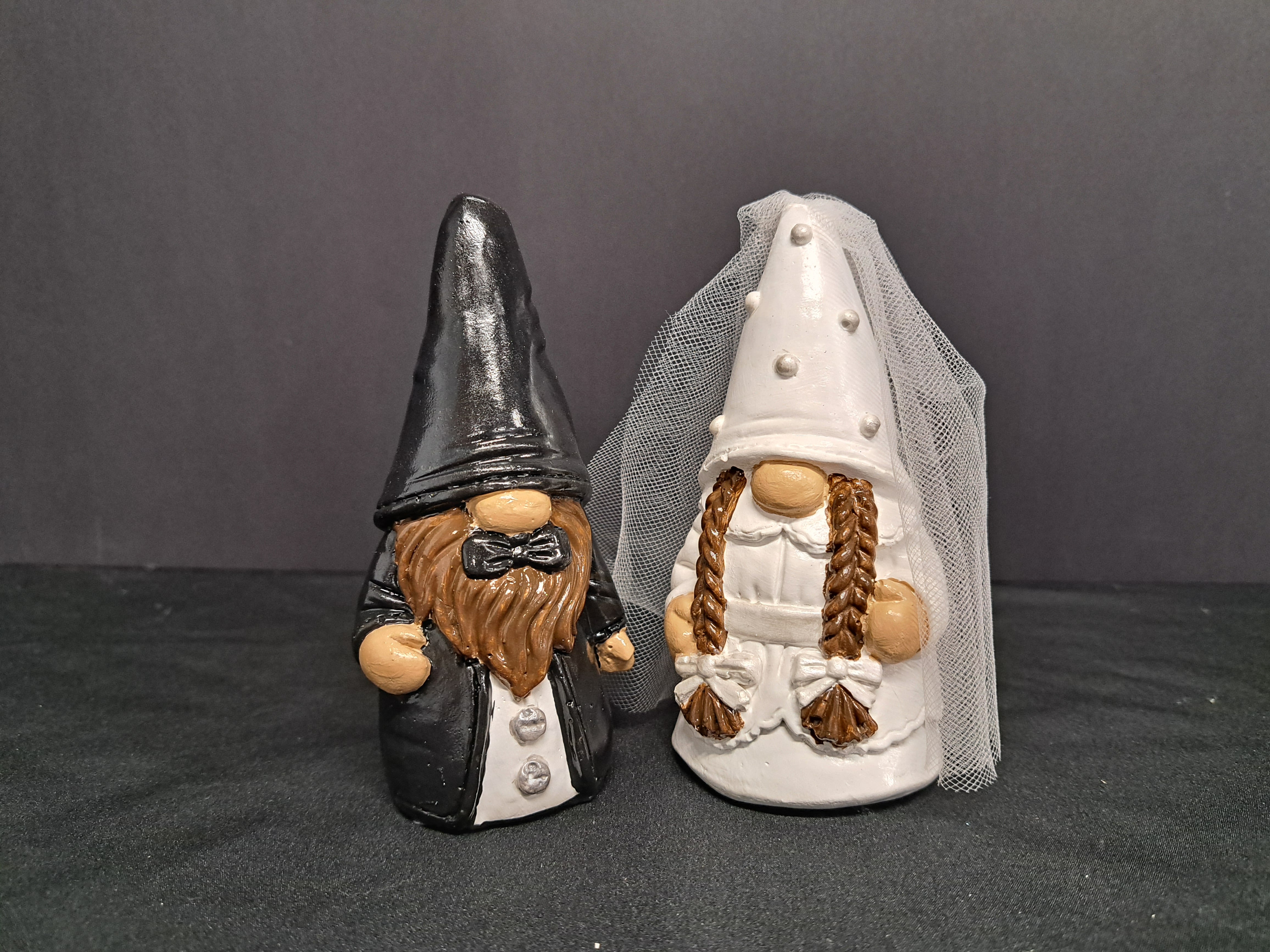 Bride and Groom Gnomes - Two whimsical ceramic wedding gnomes make an unexpected and delightful accent for weddings and bridal gifts - perfect as cake table decor or a keepsake for the newlyweds. As a set designed for weddings, these bride and groom gnomes bring a playful touch to an anniversary, engagement party, or reception sweetheart table, giving the person you're celebrating a charming reminder of the day.  These two can be coustomized allow 2 weeks for delivery. They are hand made each unique and special. 