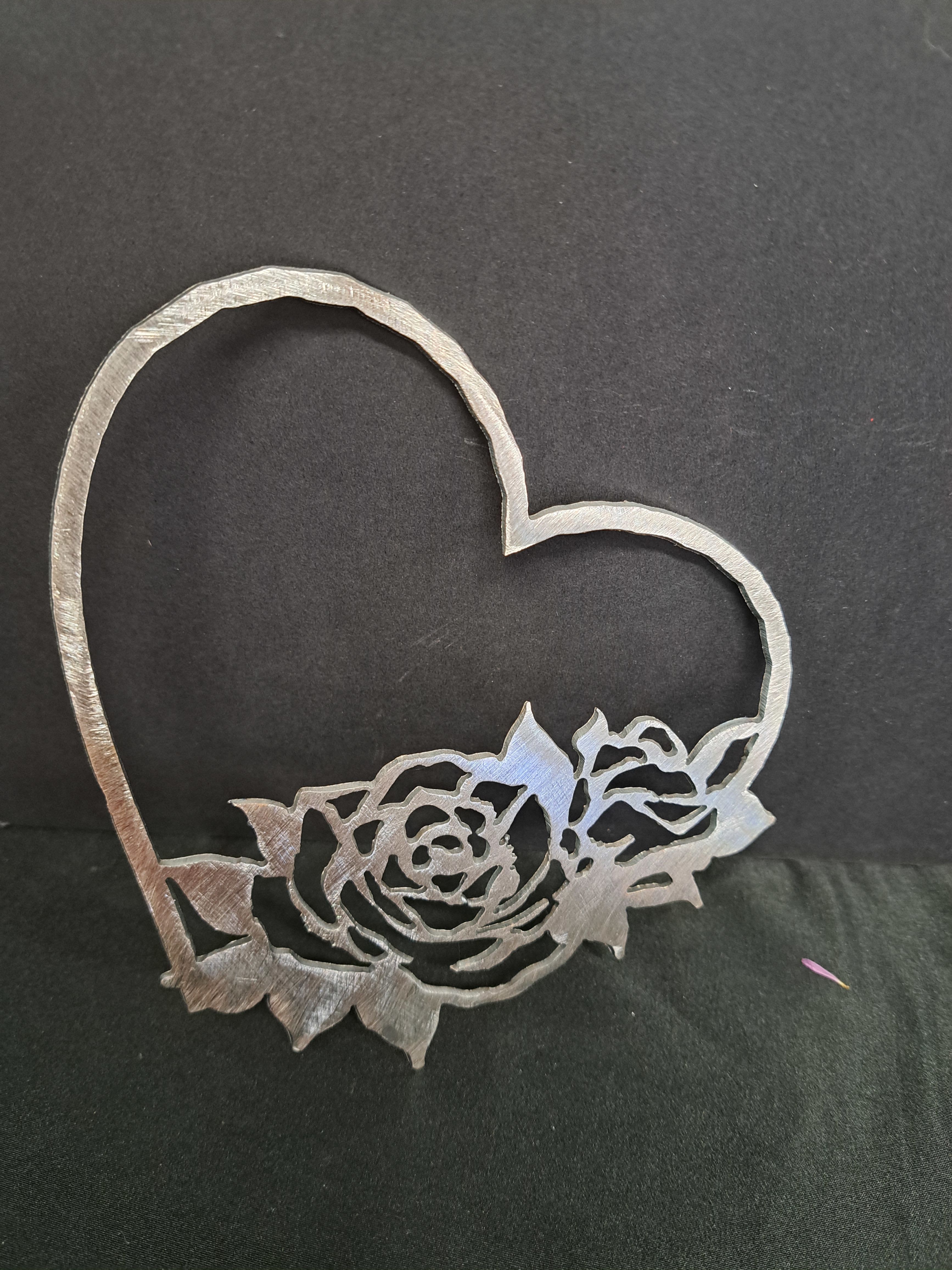 Metal Heart wall hanger open rose - A silver-toned metal heart wall hanger shaped like an open rose silhouette makes a quietly romantic statement for an anniversary, wedding, or as a heartfelt home accent. This metal heart wall hanger for wedding or anniversary décor pairs the timeless symbol of love with an elegant, monochrome finish-perfect for the person you're celebrating or to mark a special milestone.