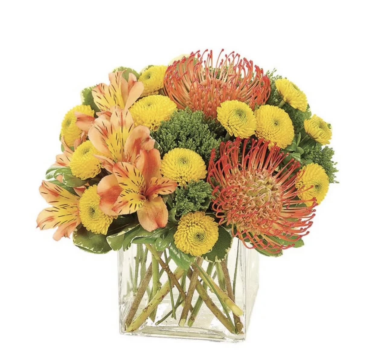 Yellow and orange mixed flower arrangement in a clear square vase