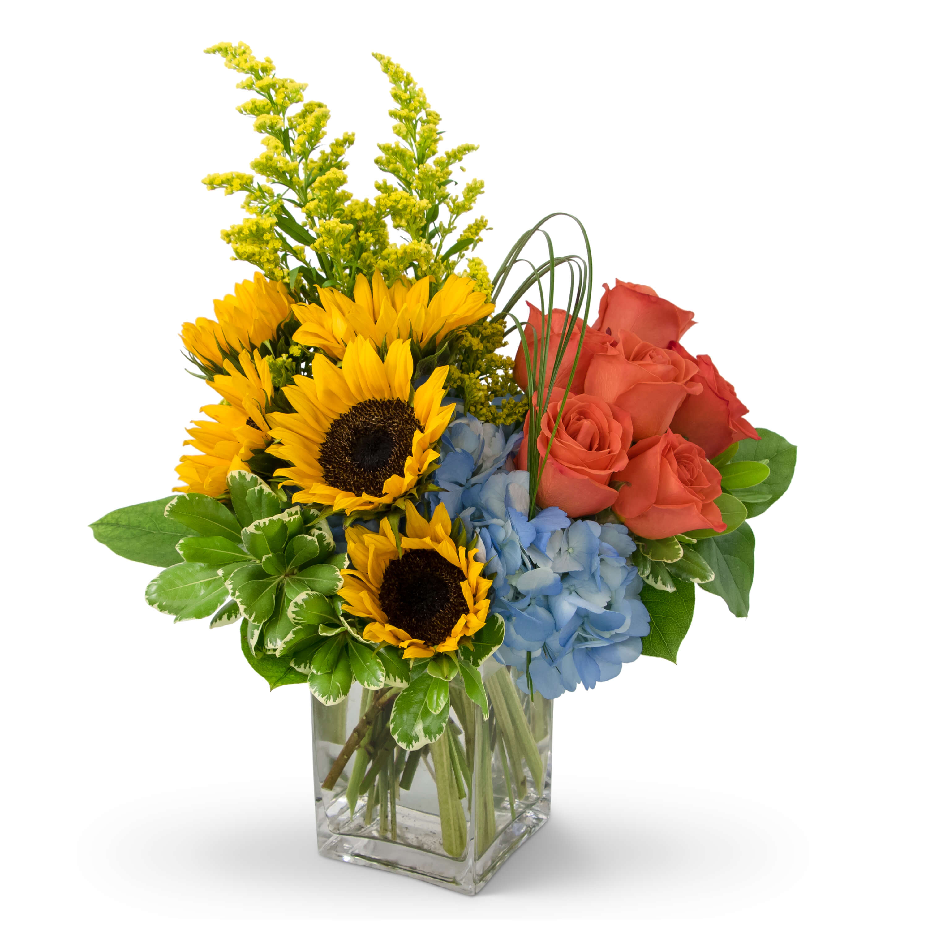 Bouquet of sunflowers, coral roses, and blue hydrangeas in a clear glass vase