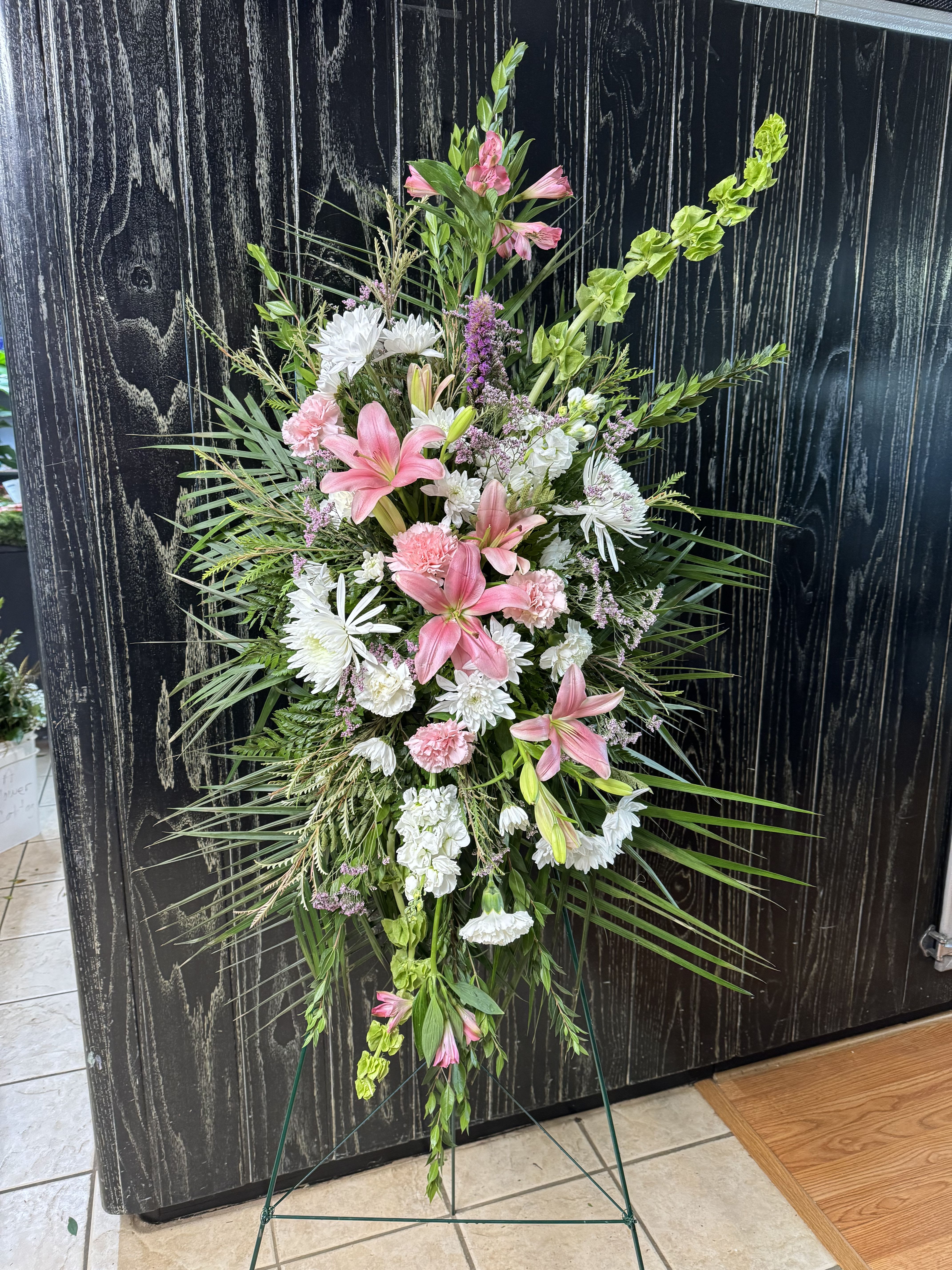 Tall standing floral spray with pink lilies and white blooms