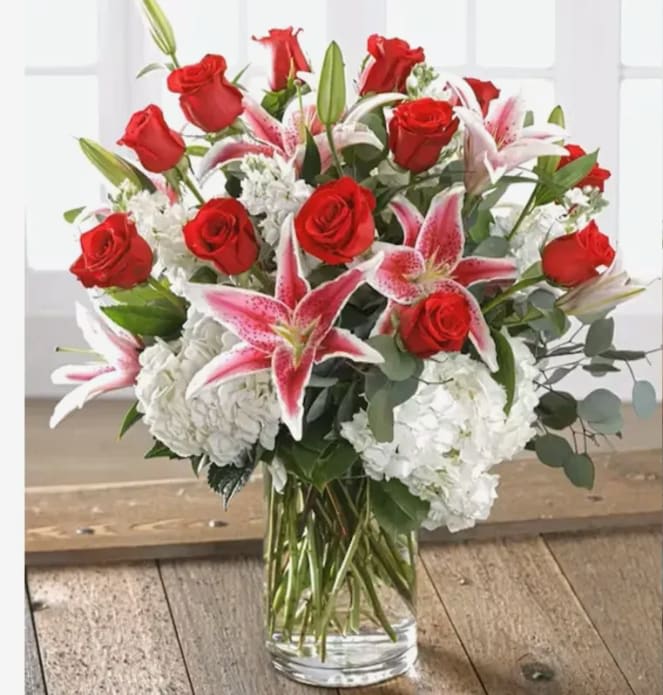 Lovestruck - She will love our combination garden of 12 exclusive Ecuadorian Red Andes Roses and Dutch garden flowers including full-bloom garden hydrangea and fragrant stargazer lilies bursting from a chic glass vase. Approximately 27"H x 19"W