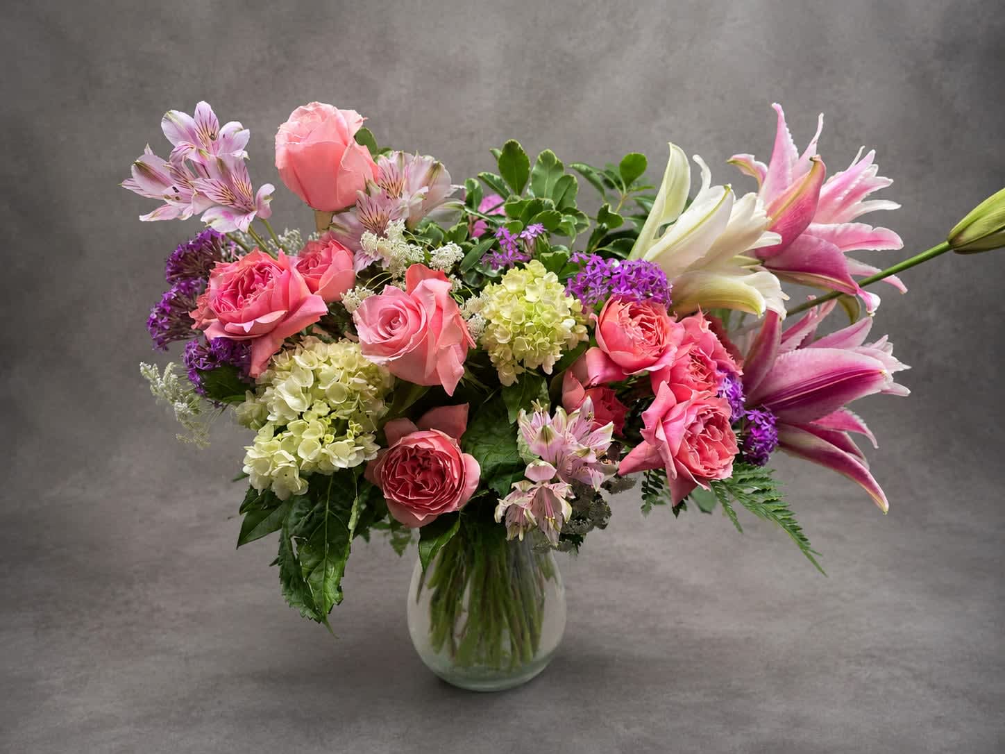 Sweet Enchantment - Romantic shades of blush, pink, cream, and lavender blend together in this garden-style arrangement. Featuring premium roses, lilies, hydrangea, and seasonal accents, Sweet Enchantment offers a soft and sophisticated expression of love, appreciation, or celebration.