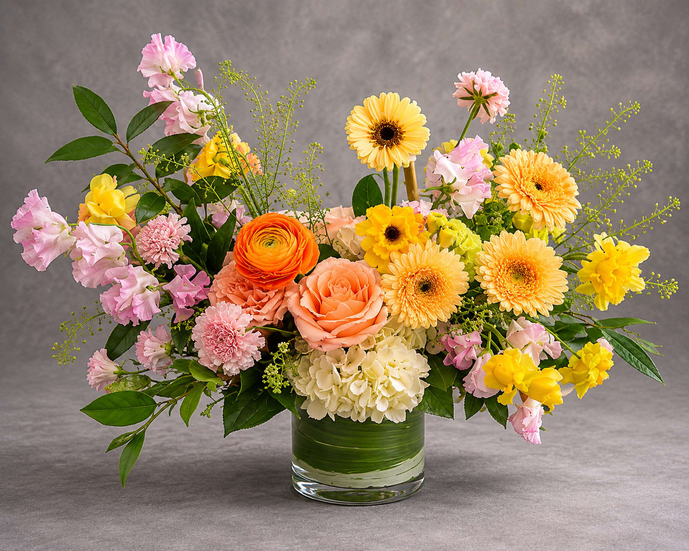 Spring Melody - A harmonious blend of peach, blush, cream, and golden blooms creates a design that feels fresh, elegant, and full of life. Featuring premium seasonal flowers arranged in a loose garden style, Spring Melody captures the beauty of spring in every stem.