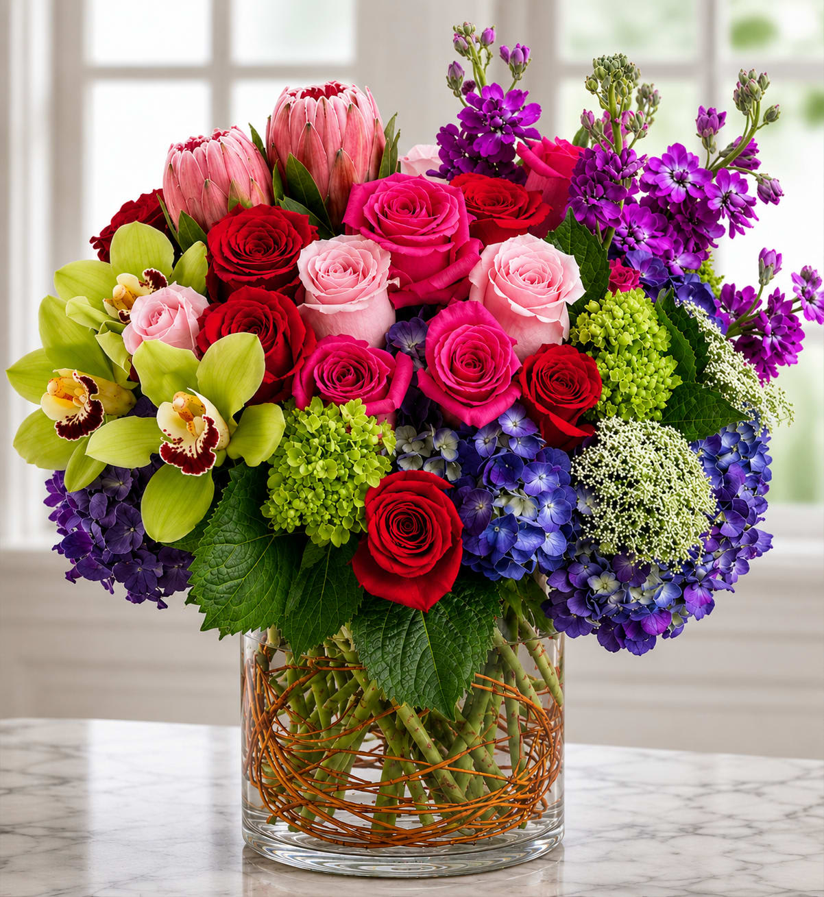 Euphoria - If luxurious excellence is what you desire, this magnificent bouquet is unmatched. Boasting only the most premium of floral varieties, including unique hydrangeas, exotic cymbidium orchids, long-stem roses, protea, and much more!