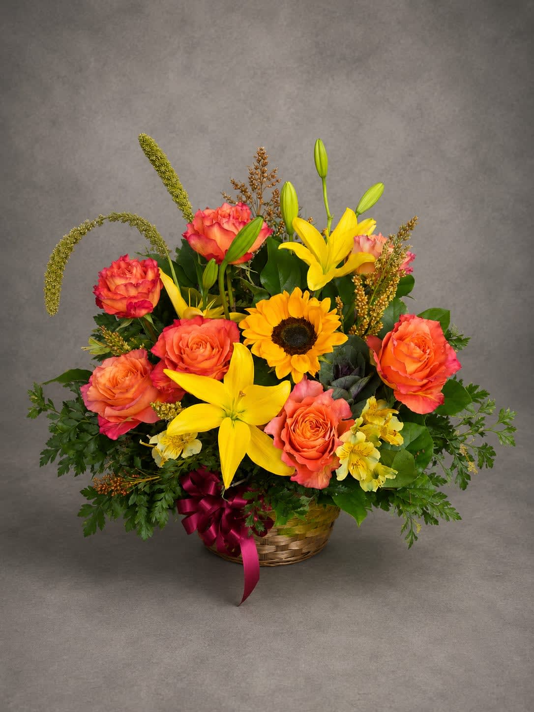 Sunset Meadow - Inspired by the warm colors of a Texas sunset, this vibrant arrangement features sunflowers, roses, lilies, and seasonal accents in rich shades of gold, orange, and coral. A joyful design perfect for celebrations and everyday moments alike.