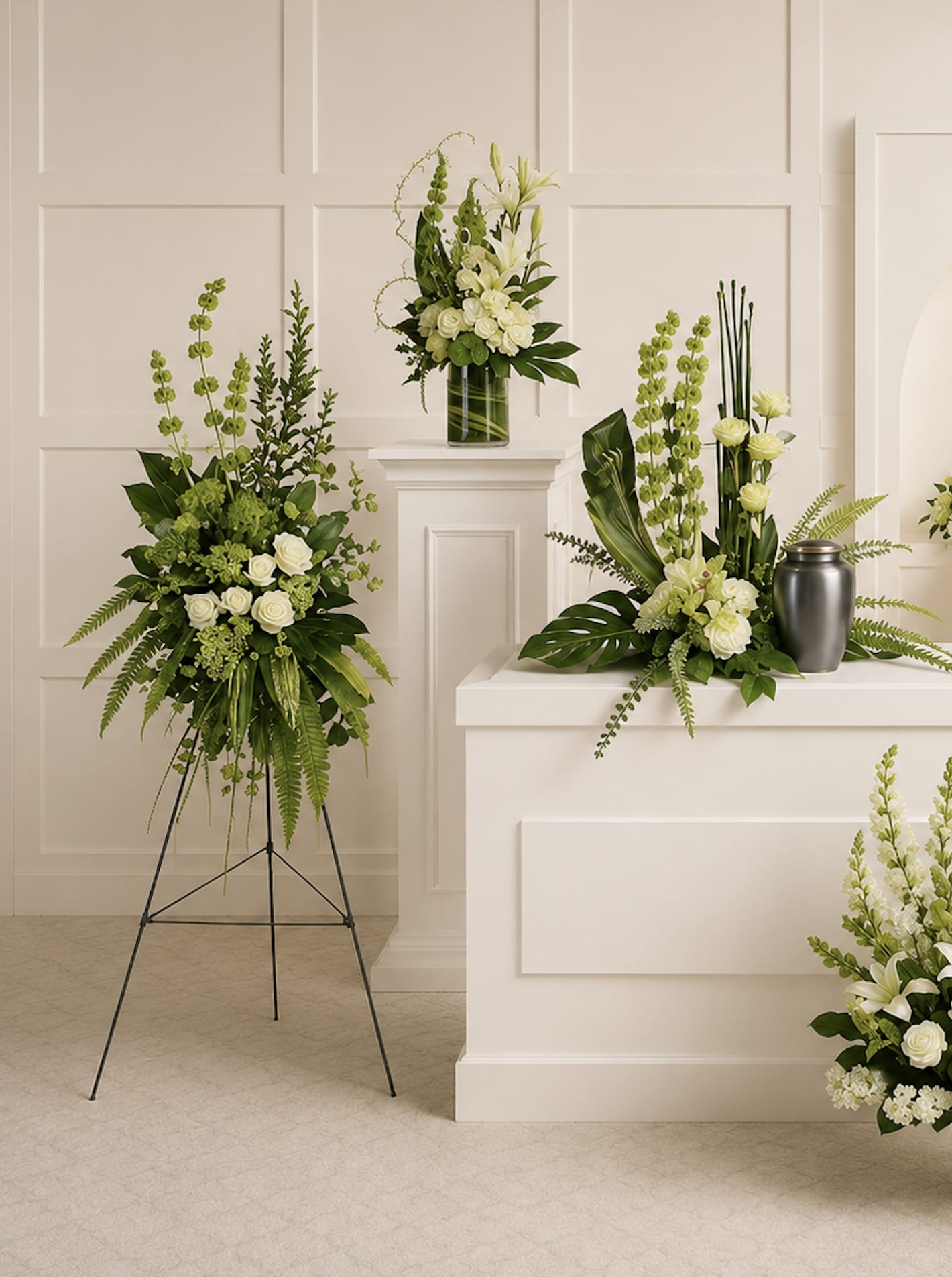 Tranquil Peace Collection - Calming white blooms and unique, sculptural greens give this collection of six hand-made sympathy pieces a tranquil, zen-like feel that's perfect for the service.  Picture frame and urn not included.  Upgrade replaces the urn spray with a casket spray.