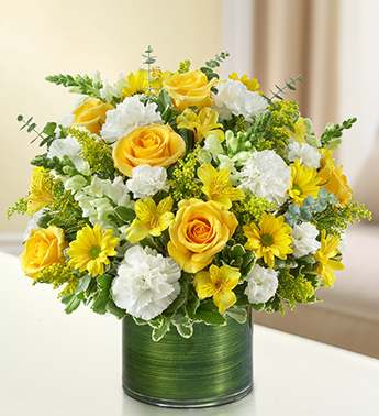 Cherished Memories - Yellow and White - Honor the memory of a loved one with a sympathy arrangement for the home or service. A vivid yellow and white bouquet of roses, snapdragons, alstroemeria, carnations and more is arranged in a classic cylinder vase to pay tribute to a beautiful life. Arrangement measures approximately 16"H x 14"W. We hand-design each arrangement, so colors, varieties, and vase may vary due to local availability.