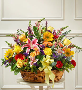 Bright Flower Sympathy Arrangement in Basket - In times of sorrow and loss, finding the perfect expression sympathy can be very difficult. Let them know there are brighter days ahead with this basket full of fresh and colorful blooms. Gathered with yellow roses, orange spray roses, sunflowers and more to offer comfort while also serving as beautiful tribute to a life well lived. Basket arrangement of fresh, bright yellow roses and orange spray roses, lilies, sunflowers, Gerbera daisies, carnations and more, designed in an elegant handled basket. Appropriate for family, friends or business associates to send directly to the funeral home. Approximately 28"H x 24"W