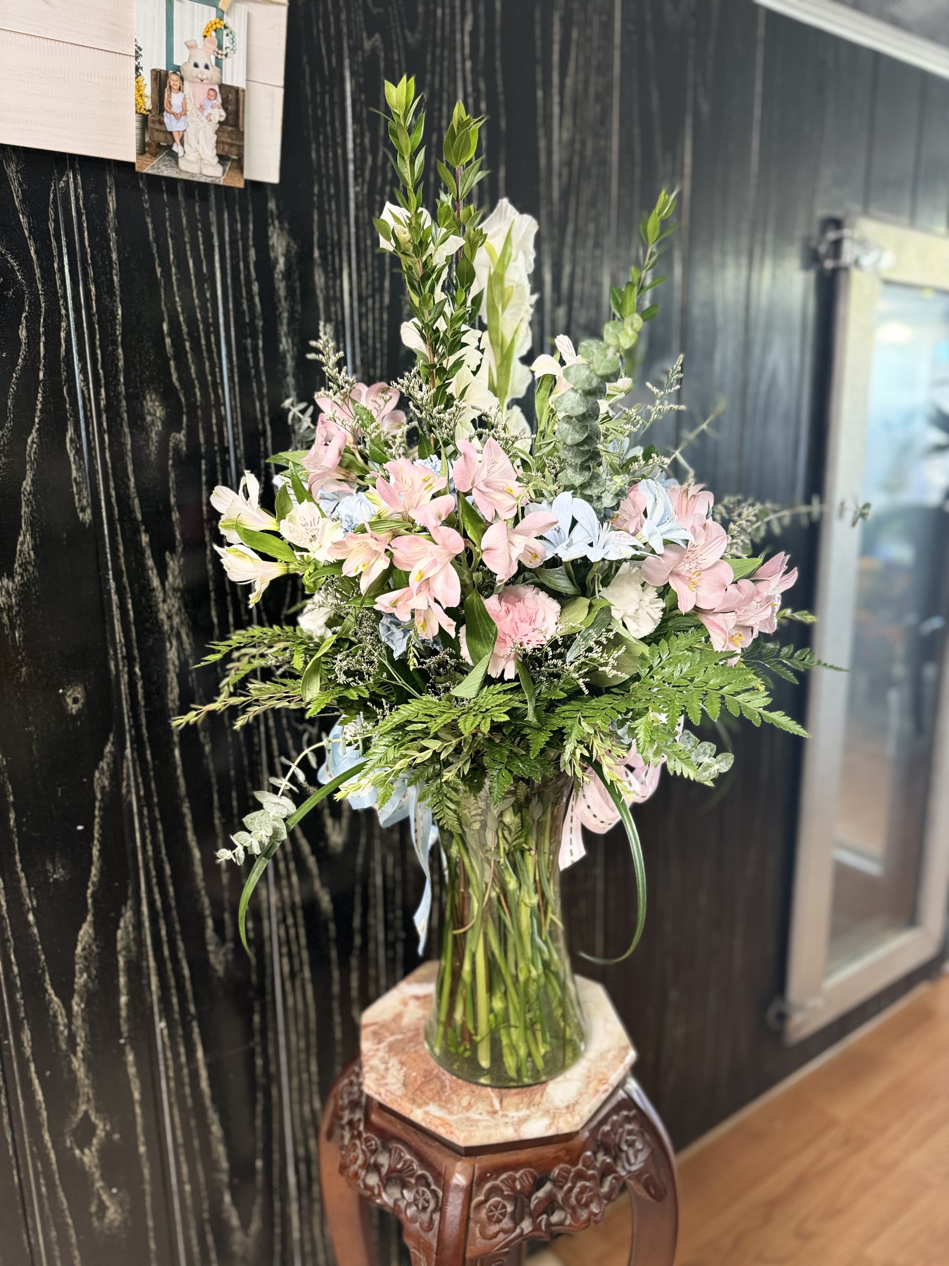 Tall bouquet of pink and white flowers in a clear glass vase