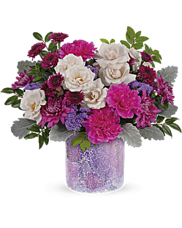 Shining Beauty Bouquet - Go for the glam this Mother's Day with a gift that sparkles as brightly as she does--a breathtaking rose bouquet in a vibrant mosaic glass keepsake vase. This bouquet includes crème spray roses, purple button spray chrysanthemums, hot pink carnations, purple cushion spray chrysanthemums, lavender sinuata statice, dusty miller and huckleberry.  Orientation: All-Around Container may vary 