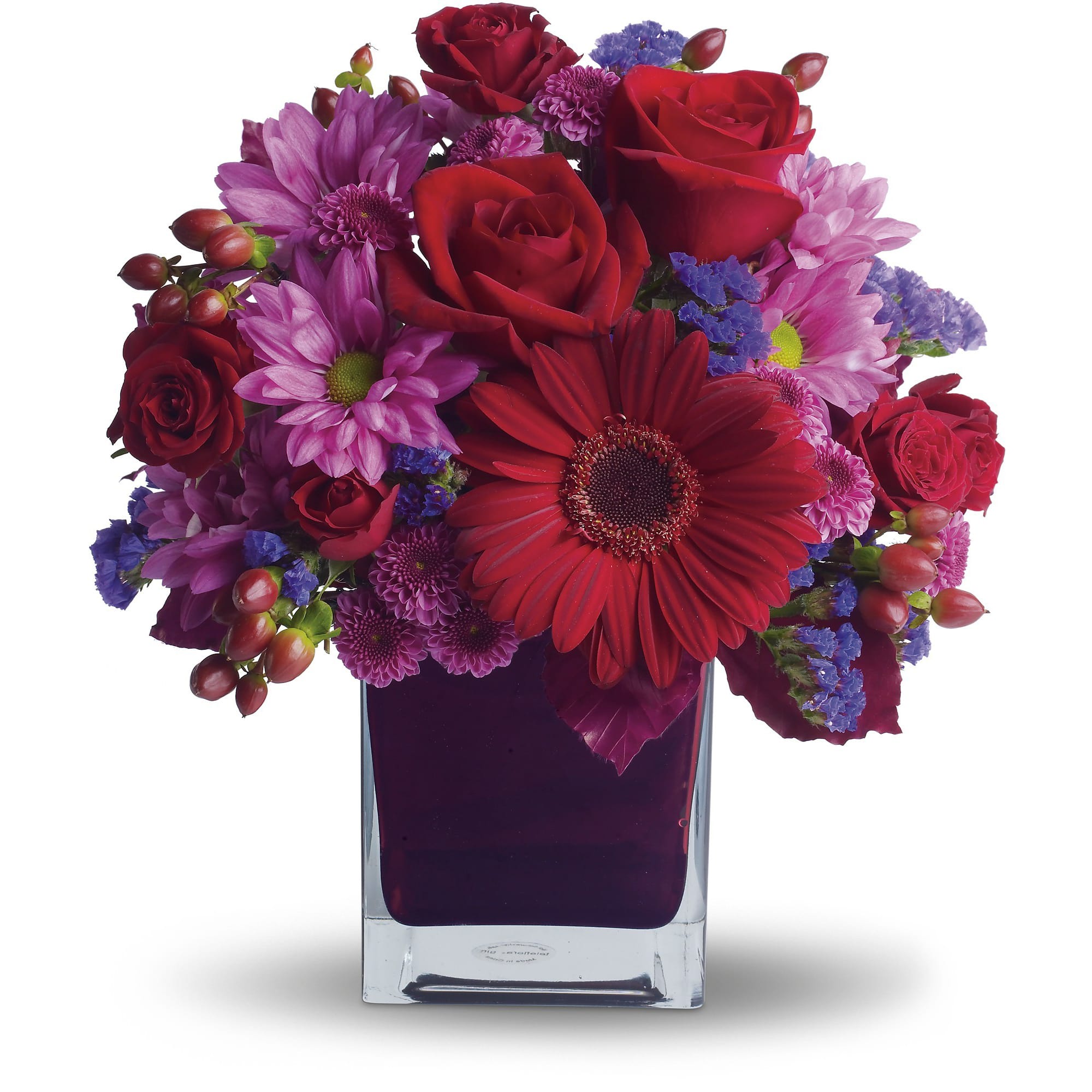 Red roses and purple daisies in a square glass vase