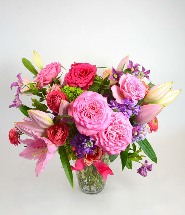 Pink and purple mixed bouquet in a clear glass vase