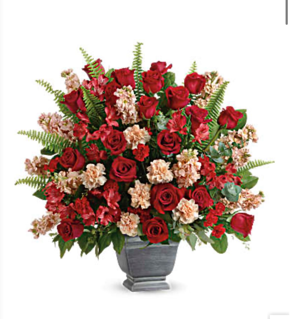 Red roses and pale carnations in a gray urn vase
