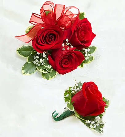 Red rose corsage and boutonniere with ribbon accents