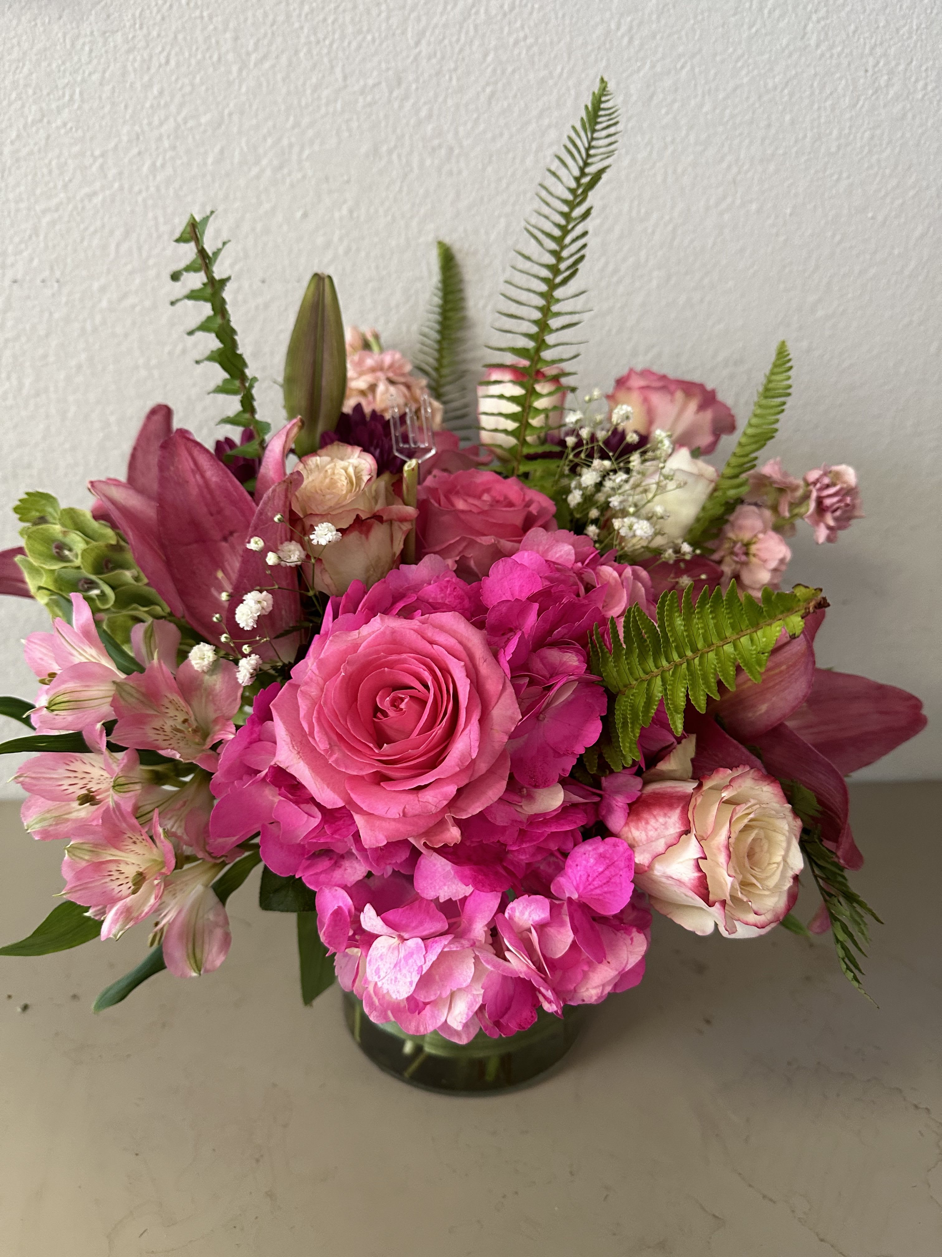 Pink rose and hydrangea bouquet in a glass vase