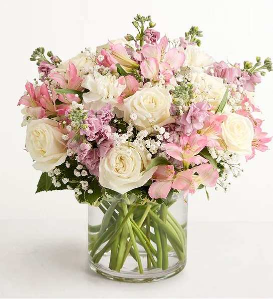 Loving Sentiments Pink &amp; White - Our graceful arrangement in shades of blush pink and creamy white is a touching expression of sympathy for someone you care about. Cascading blooms are hand-gathered with lush greenery inside a clear cylinder vase, creating a beautiful tribute to the memory of a loved one, while providing comfort and support during a difficult time.