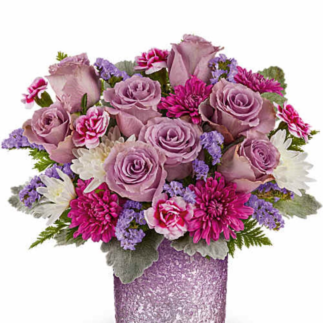 Lavender roses and pink daisies in a glittery purple vase