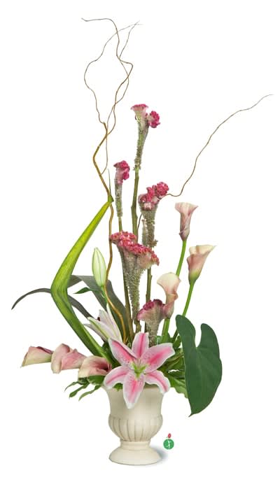 Tall arrangement of pink lilies and calla lilies with linear greenery in a cream urn vase.