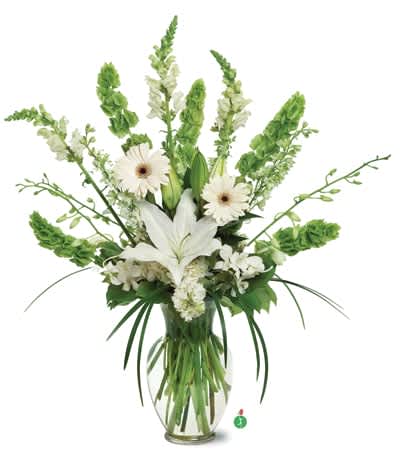 Tall white lily and gerbera arrangement with green Bells of Ireland in a clear glass vase