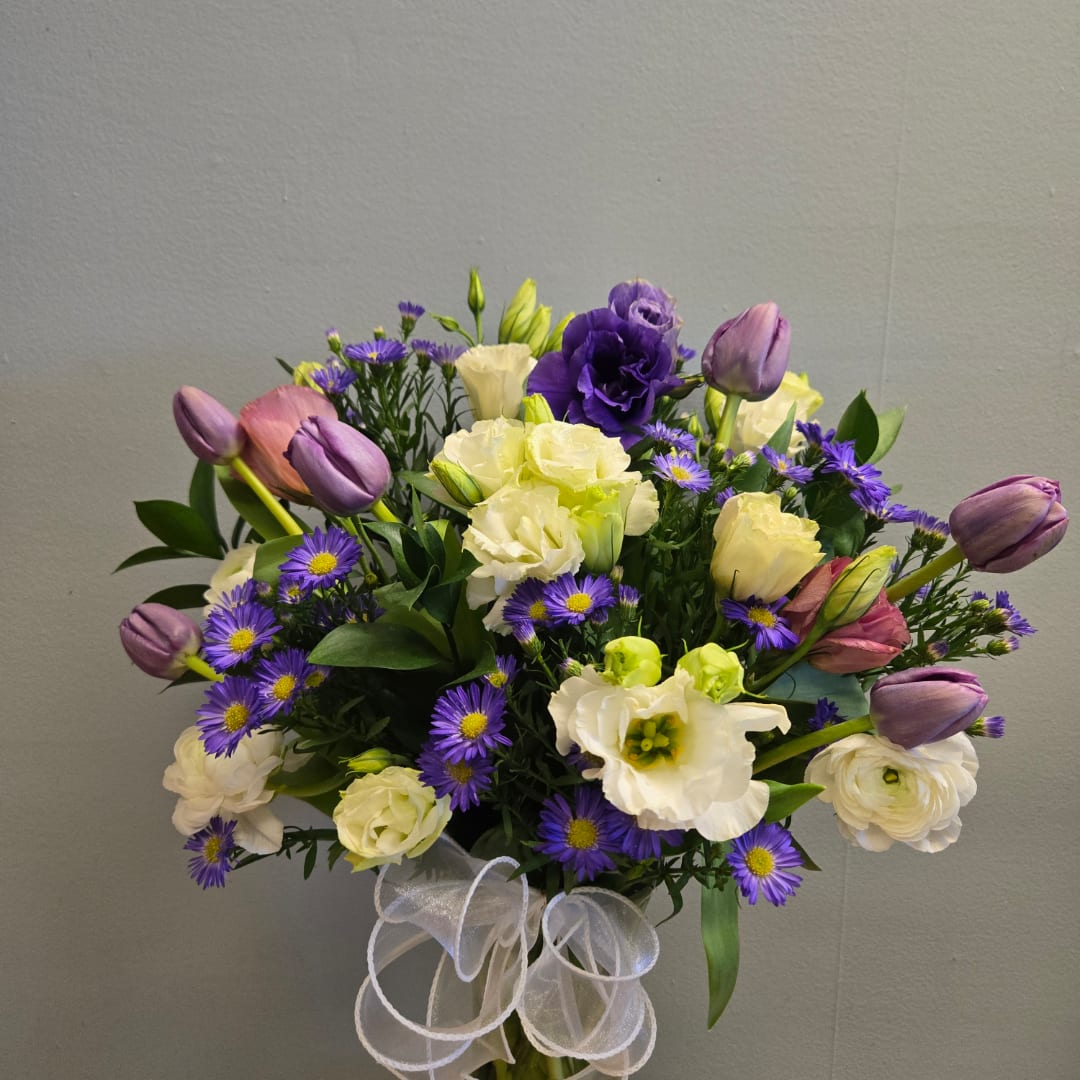 Bouquet of purple tulips, white lisianthus, and small purple daisies