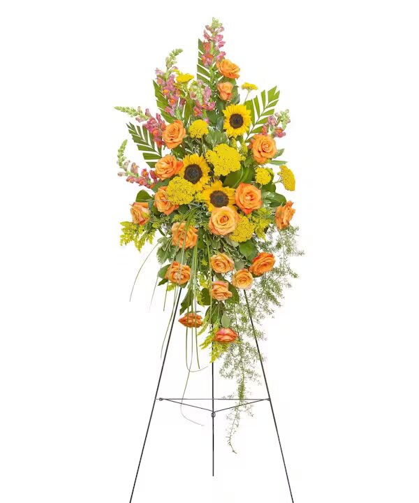 Tall floral standing spray with orange roses and yellow sunflowers on a metal easel