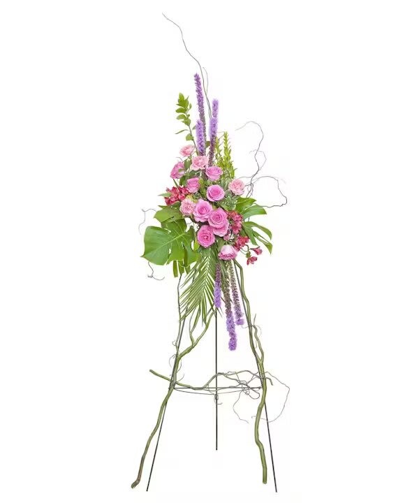 Tall floral standing arrangement with pink roses and purple spikes