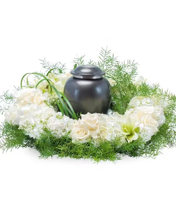 White floral wreath around a dark urn-shaped container
