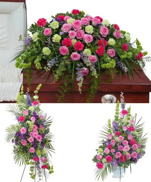 FOREVER CHERISHED TRIO - Forever Cherished Trio includes a casket spray, standing easel spray, and crescent urn arrangement.  The "Forever Cherished Trio" from Morningside Florist is a touching and vibrant tribute that expresses heartfelt sympathy and everlasting remembrance. This trio encompasses a rich tapestry of color and life, beautifully arranged to honor a loved one with a visual symphony of affection and respect. The collection includes a casket spray, a standing spray, and an elegant vase arrangement, each bursting with an array of roses in shades of pink and lavender, carnations, and complementary greenery that convey a message of enduring love and cherished memories.  The casket spray is a blanket of blooms, offering comfort in its lush, full display of florals, symbolizing the rich and full life of the dearly departed. The standing spray stands as a pillar of honor, its vertical reach towards the heavens a poignant reminder of the soul's ascent. At the same time, the vase arrangement provides a gentle reminder of the beauty and grace the loved one brought into the lives of those they touched. Opting for the "Forever Cherished Trio" from Morningside Florist means selecting a floral set that adorns the final farewell with elegance and offers a profound visual solace to the bereaved, encapsulating the joy and color the departed added to the world. It is a choice that celebrates life even in the face of loss and ensures that the final memory is as beautiful and vibrant as the bond shared with those who grieve.
