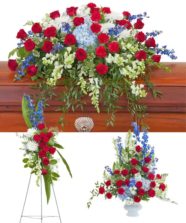 HONOR TRIO - A patriotic casket spray, standing spray, and urn.  The "Honor Trio" sympathy set from Morningside Florist offers a poignant and patriotic homage, suited for honoring the life of someone who has served or possessed a deep love for their country. This striking collection, featuring a casket spray, a standing spray, and an urn, is meticulously arranged with the noble hues of red, white, and blue, reflecting the enduring spirit and values of the nation.  The casket spray, with its splendid red roses, signifies deep respect and heartfelt gratitude, while the pure white blooms interspersed within represent the purity of intention and a life honorably lived. Bold blue delphiniums stand out, symbolizing dignity and the serene comfort of trust in something greater than oneself. The standing spray, reaching skyward, is a visual salute to the departed, a symbol of remembrance that stands dignified amongst the gathered mourners. The urn arrangement completes the trio with a softer yet equally respectful nod, ensuring the full spectrum of patriotism and pride is beautifully displayed. Selecting the "Honor Trio" from Morningside Florist is a powerful way to communicate a final farewell full of reverence, pride, and honor. It is a tribute that speaks of a legacy intertwined with the threads of national identity and personal bravery, a fitting and solemn salute to a life that embodied the spirit of service and patriotism.