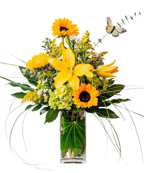 TAKING FLIGHT - Lift their spirits high. Taking Flight's sunny yellows will have them soaring with happiness. Yellow lilies, sunflowers and other flowers are playfully arranged in this sunny arrangement.  