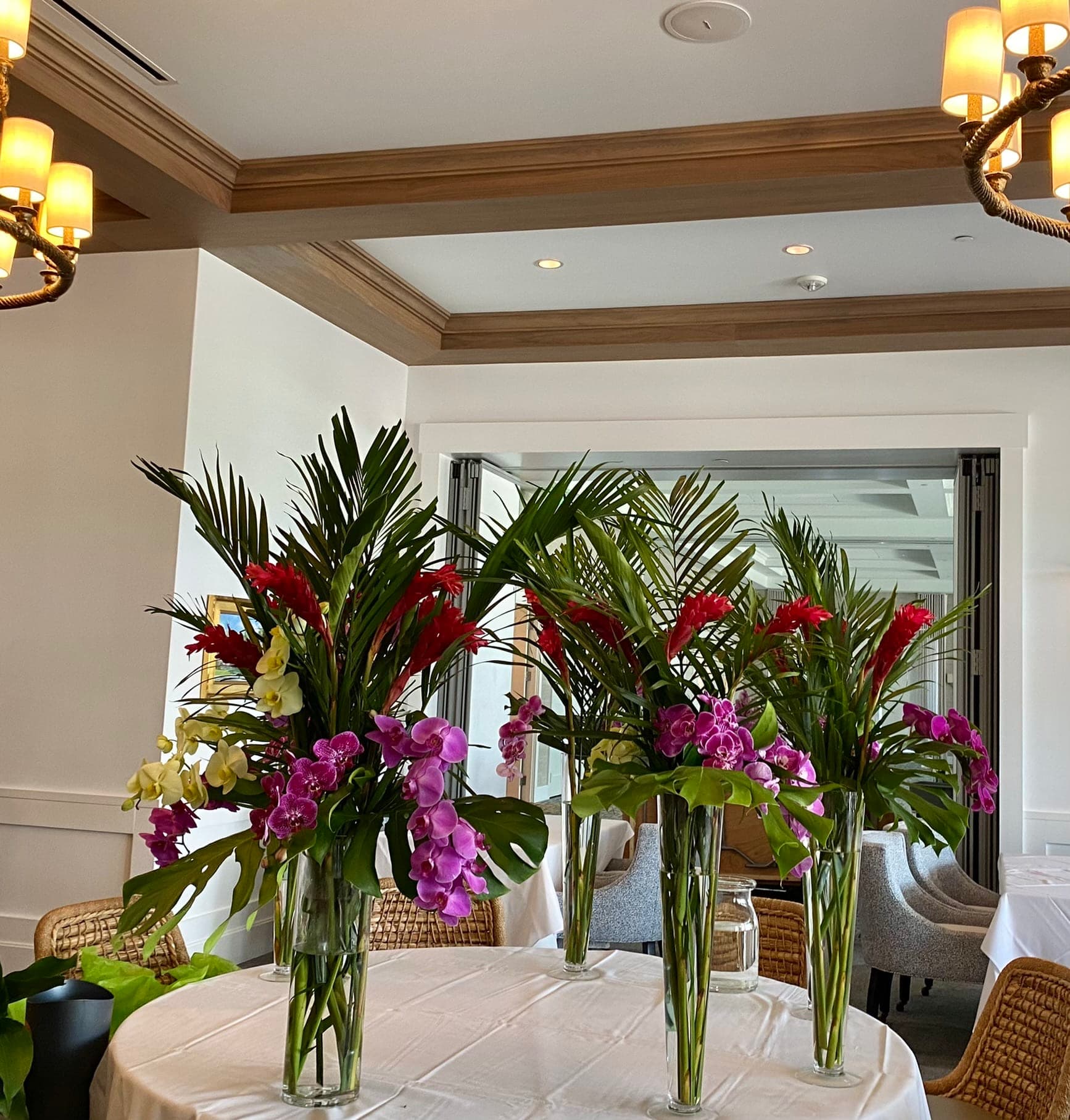 Casino Night in LYC - Orchid blooms, Ginger, green in trumpet vases . Setting up in Lauderdale Yacht Club 