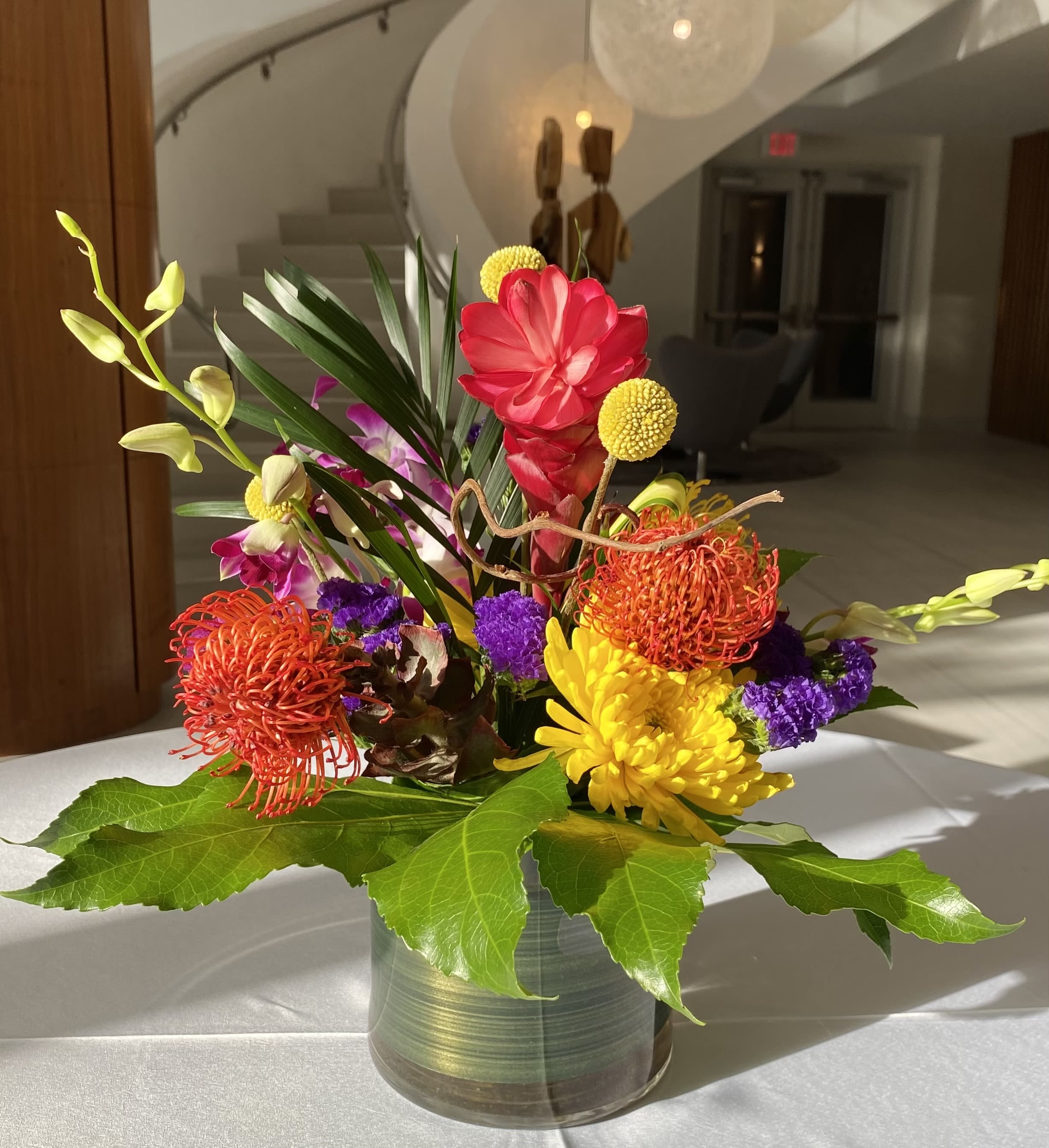 Colorful tropical flower arrangement in a glass vase