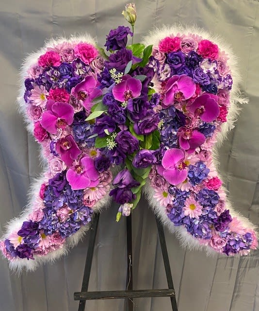 Heart-shaped floral standing spray in pink and purple tones