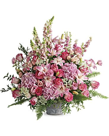 Teleflora's Graceful Glory Bouquet - Full of grace and light, this majestic bouquet of pink blooms and fresh greenery is a glorious addition to the service. Light pink hydrangea, pink roses, light pink spray roses, light pink asiatic lilies, pink lisianthus, pink larkspur, light pink snapdragons, and Queen Anne's lace are arranged with Italian ruscus, huckleberry, pitta negra, sword fern, flat fern, and lemon leaf. Delivered in Teleflora's Parisian Garden Pot. Orientation: One-Sided  SUBSTITUTION POLICY – Always deliver the freshest flowers! Please note the bouquet pictured reflects our original design.  If the exact flowers or container in this arrangement are not available, our local florists will create a beautiful bouquet with the freshest available flowers.