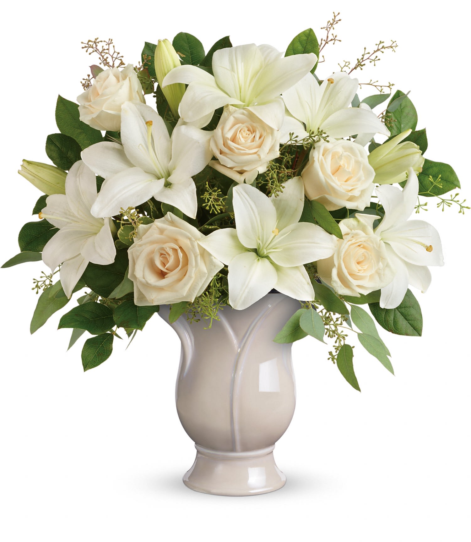 Wondrous Life bouquet - Celebrate a wondrous life with this timeless tribute of pure white lilies and roses, arranged in a graceful tulip-shaped ceramic vase.This monochromatic bouquet features crème roses, white asiatic lilies, seeded eucalyptus, and lemon leaf. Delivered in a Blooming Tulip vase. Approximately 17 1/2" W x 19" H