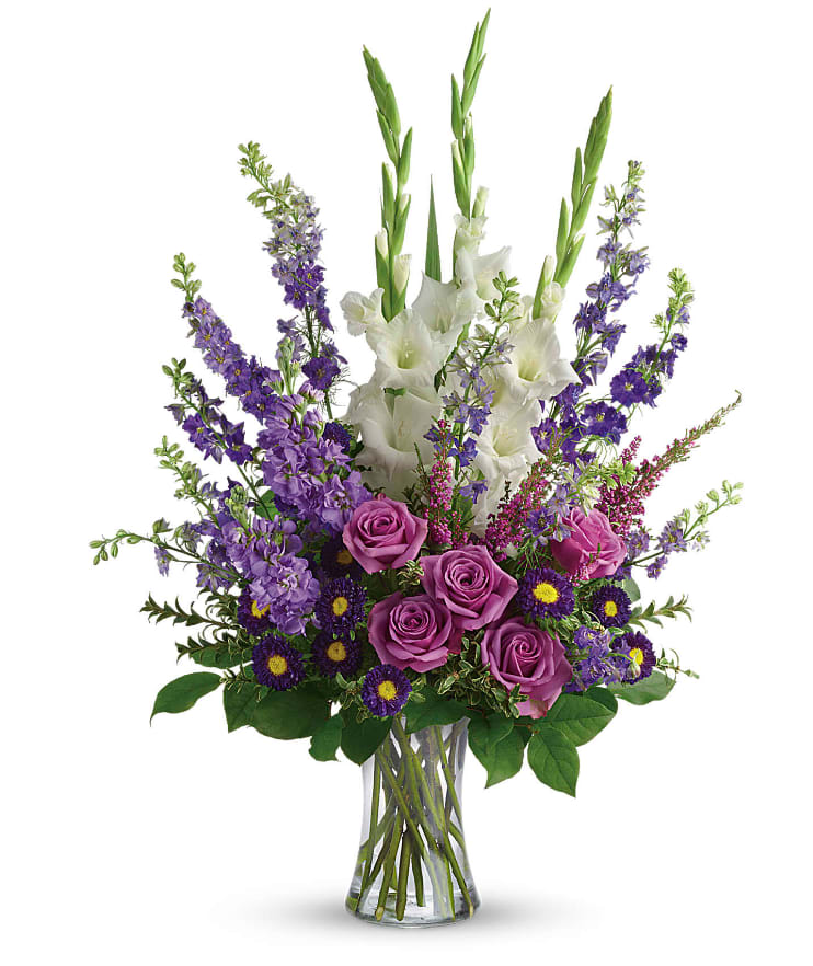 Joyful Memory - Lavender and white sympathy flowers make a grand statement in this joyful bouquet. Cherish your memories with this lasting remembrance of lavender larkspur and roses, deep purple asters, pure white gladioli and the softest pink heather. A classic assortment of flowers such as lavender larkspur, stock and roses, plus purple asters, white gladioli and pink heather. Approximately 22 1/2" W x 32" H