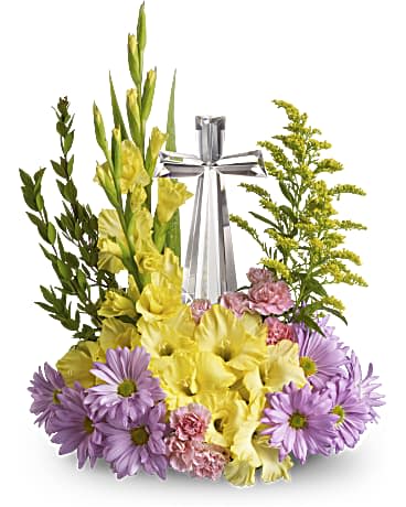 Teleflora's Crystal Cross Bouquet - Make this Easter extra special for someone you love with radiant flowers cradling an exquisitely crafted Crystal Cross. It will be an endless source of joy and inspiration. Pink roses, hot pink spray roses, lavender daisy spray chrysanthemums, miniature pink carnations and solidago accented with assorted greenery are delivered with a 7 ½" high, multifaceted Crystal Cross. Orientation: One-Sided