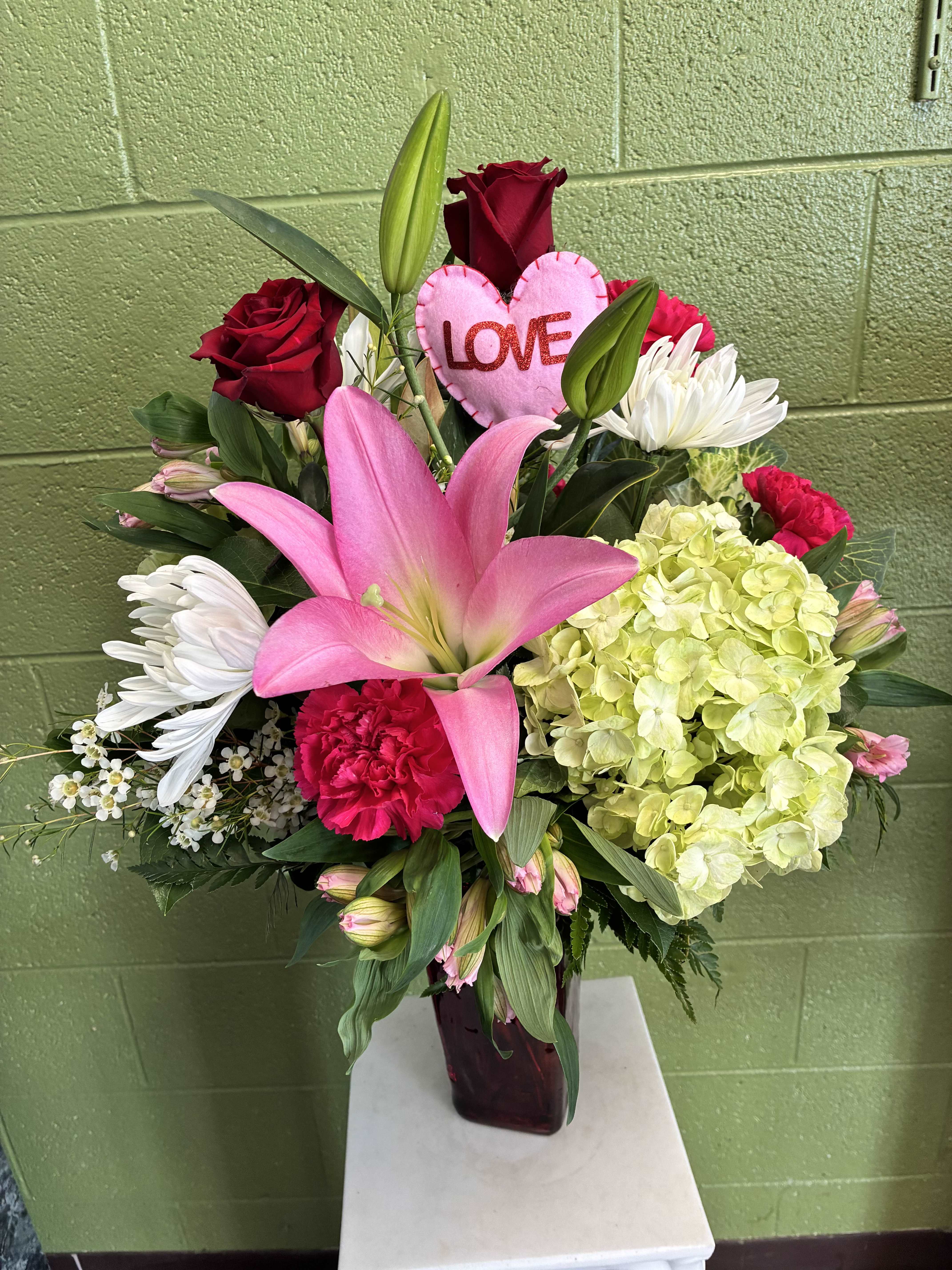 Pink lily and red rose arrangement with a heart-shaped LOVE pick