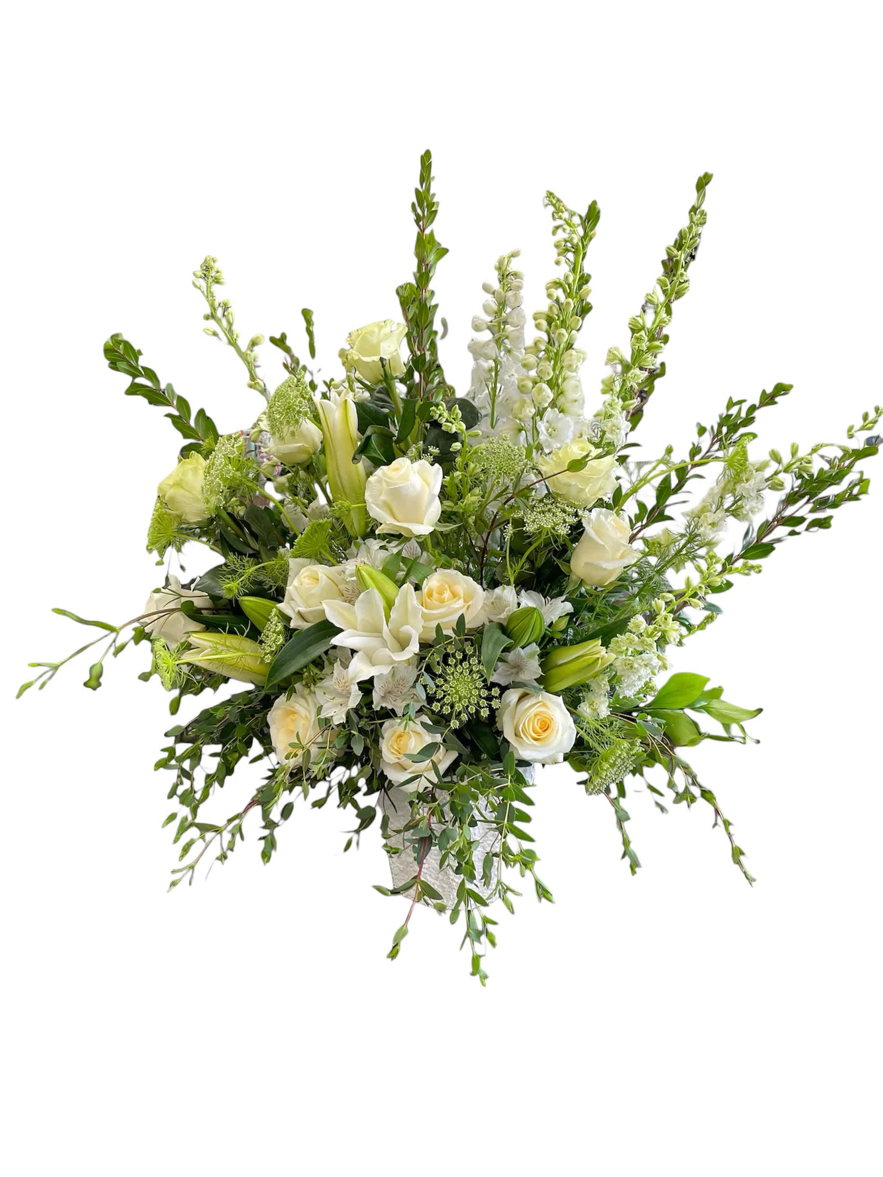 White roses and lilies in a tall, airy arrangement