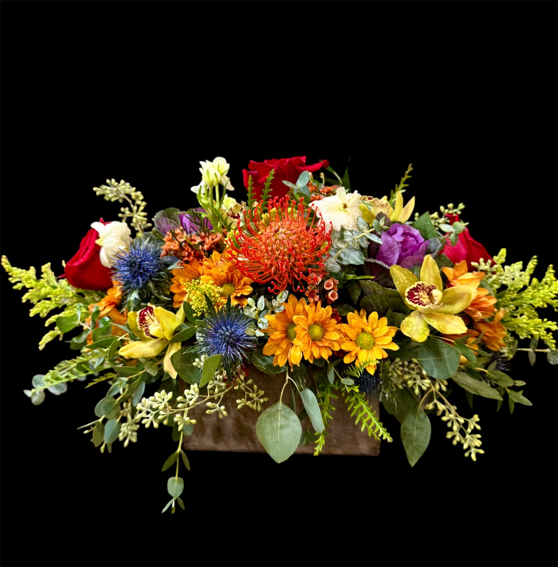 Colorful mixed flower arrangement in a rectangular container
