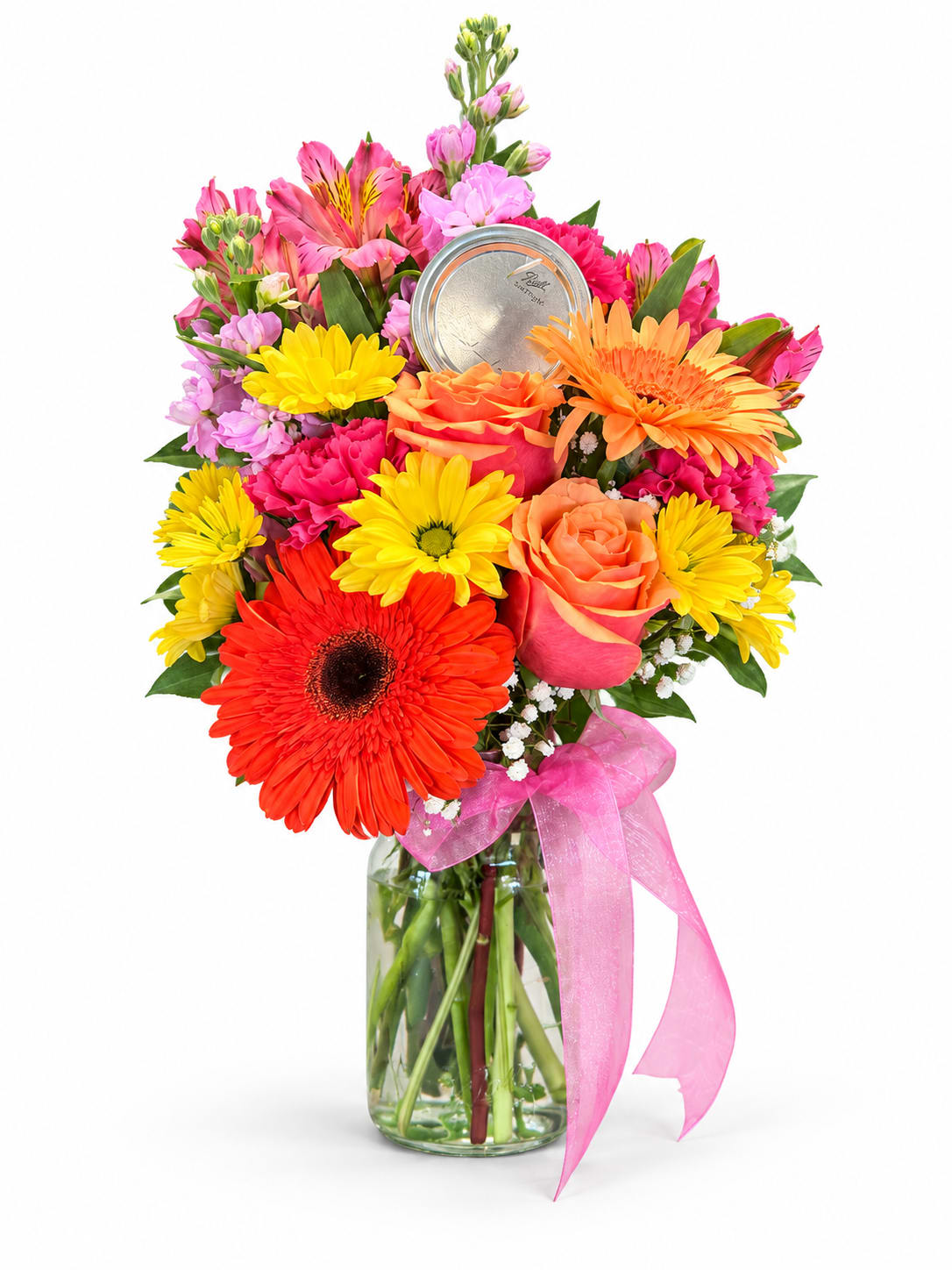 Colorful mixed bouquet in a glass vase with a pink ribbon