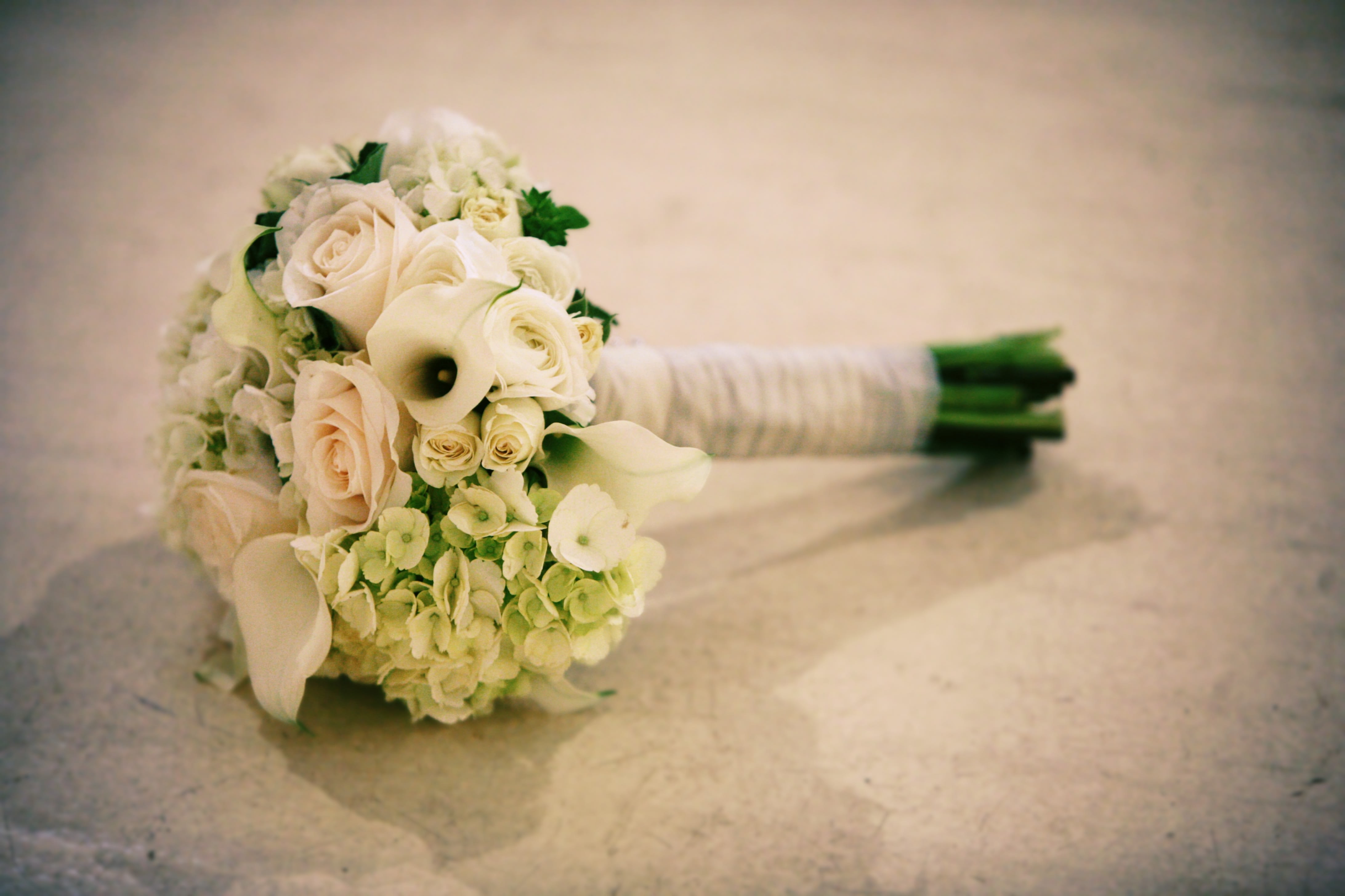The pristine bouquet - Simply lush and elegant wedding  bouquet. White, light green, and cream floral finished off with ivory satin ribbon. 