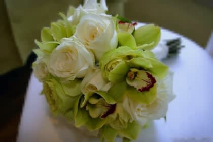 Green and Creamy wedding bouquet  - Vibrant green cymbidium orchids paired with cream and white roses and white hydrangea. Finished off with satin ivory ribbons. 
