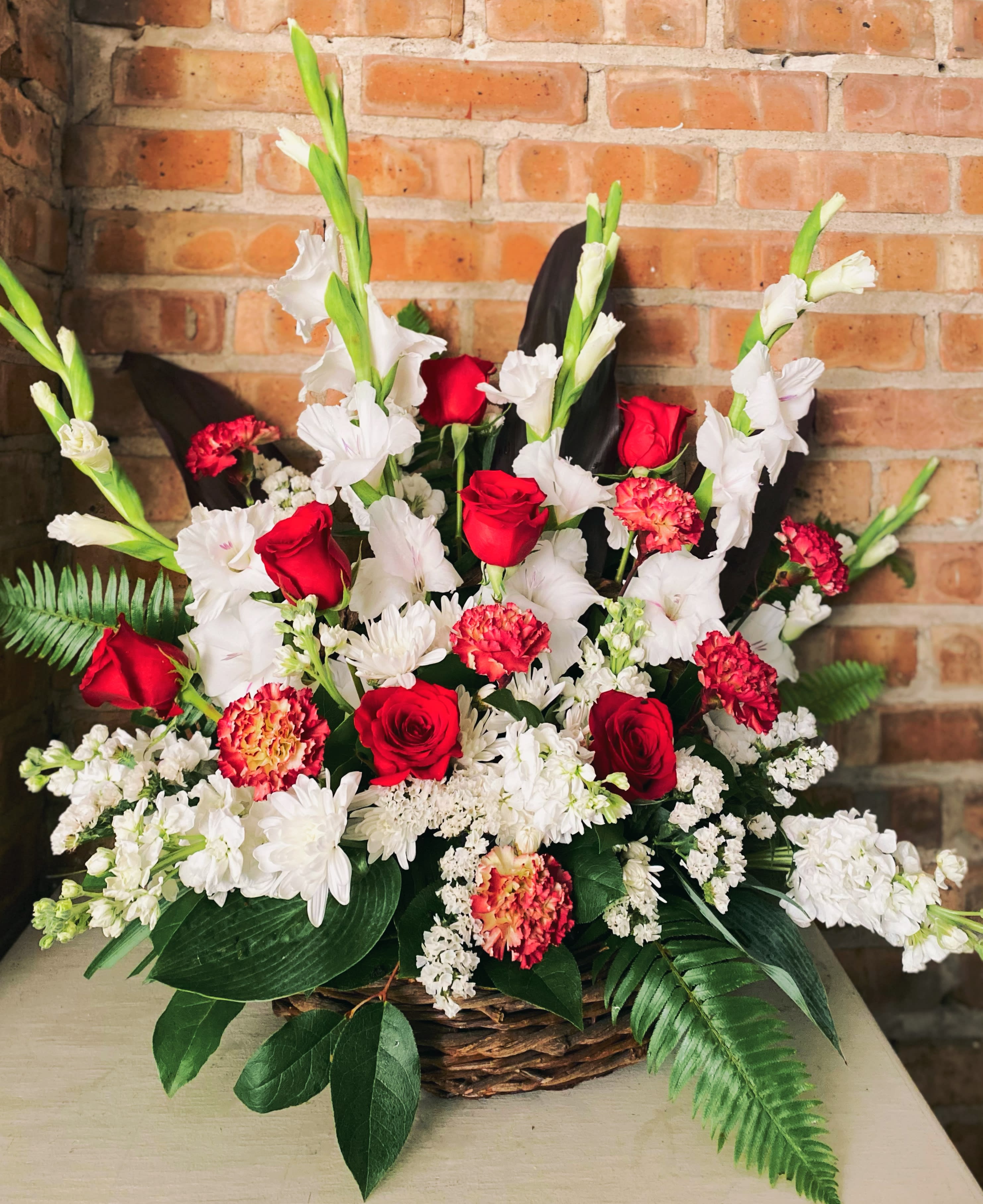 Joy Sympathy Basket - Joy sympathy basket is a perfect keep sake funeral arrangement or condolence arrangement. Large, lush and  simple design of roses, gladiolus, carnations and vibrant greens. This basket can be custom ordered with a different color palette. Add your preferences to your order or call us after you have made your online order. Approximately 20in x20. 