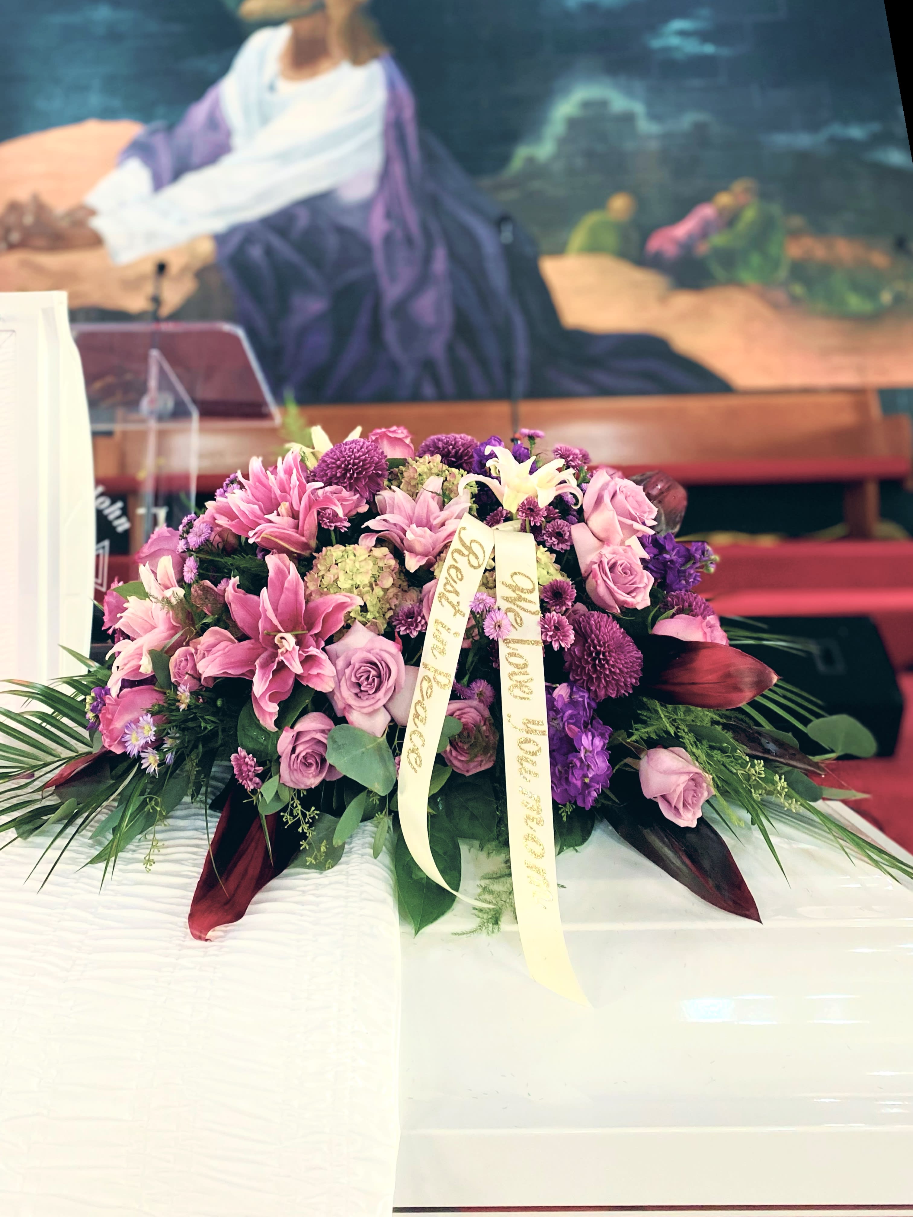 Precious casket spray - Precious casket spray Is an array of 3 colors . Please pick one dominant color and 2 accents . Roses, lilies,hydrangeas and a variety of garden blooms. This casket spray must ordered with your colors. Comes with gold letter banner. Put the banner message in your card message. 