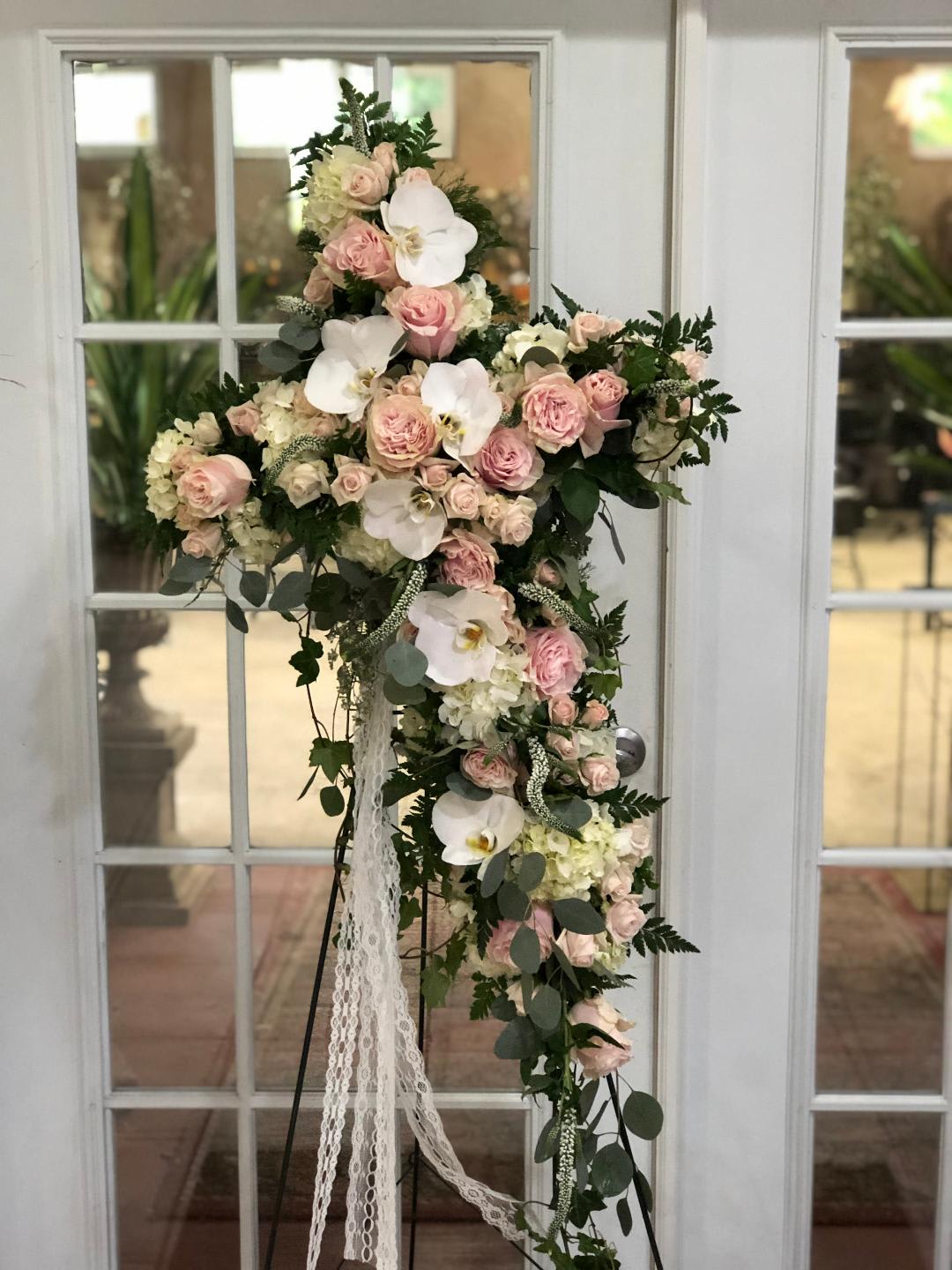 Tall floral standing arrangement with pink roses and white orchids