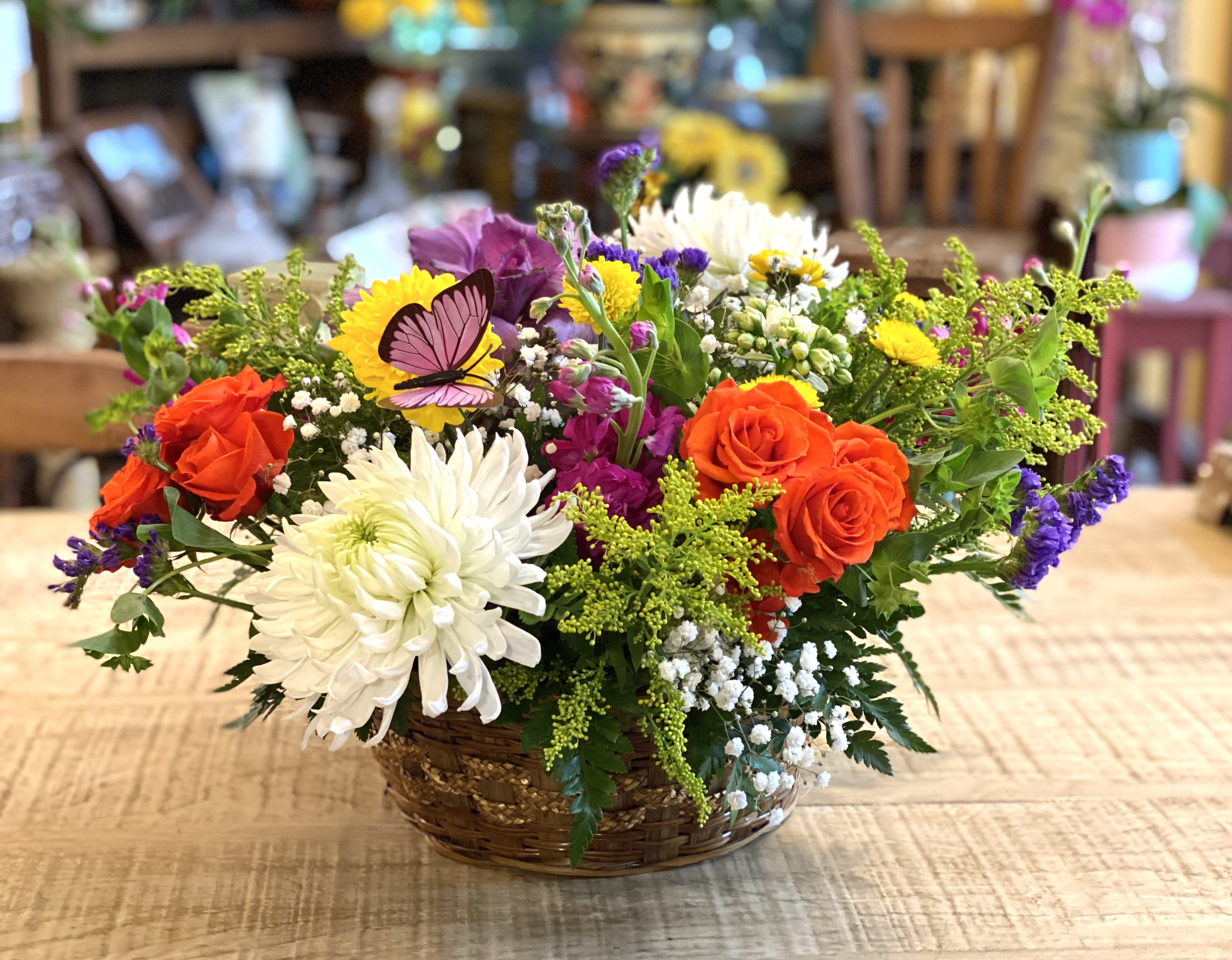 Colorful mixed flower basket with roses and daisies